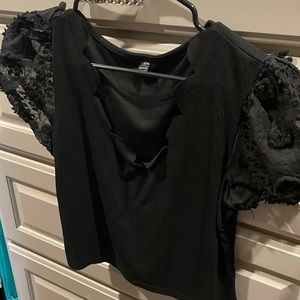 Black crop top with puffy sleeves and a scalloped neck line
